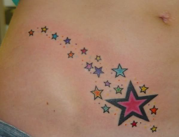 Shooting star tattoo near waistline,star tattoos,feminine tattoos